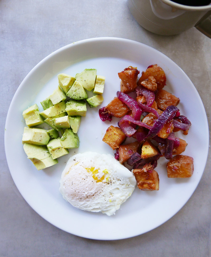 "I sit down with breakfast and get the day going. Today’s breakfast is a poached egg, a big pile of leftover veggies, and some diced avocado. I top it with hot sauce, too! Carbs, protein, and fat usually make up my breakfast — they're great for post-workout meal or just for fuel for the day!"