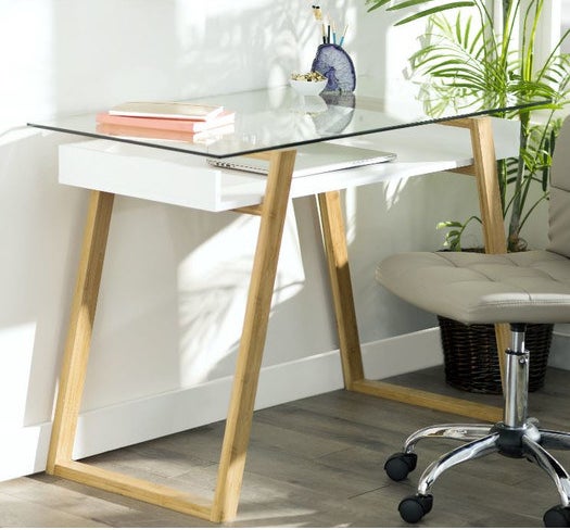 Promising review: "I am a Ph.D. student and I work at home A LOT. I also live in a studio apartment, so my space and design options are limited. When I decided to upgrade my 'office' space, I chose this desk because of it's airy quality and size. It looks great in my apartment and it's also highly functional. I don't like having a cluttered desktop, but if I don't have items that require follow-up in direct sight, I forget about them. The glass top is perfect because it allows me to place items for follow-up in sight without having a cluttered desk." —JenniPrice: $156.99 (on sale from $201.99). / Available in white (pictured) and black.