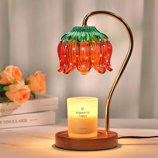 Elegant flower-shaped glass lamp next to a lit