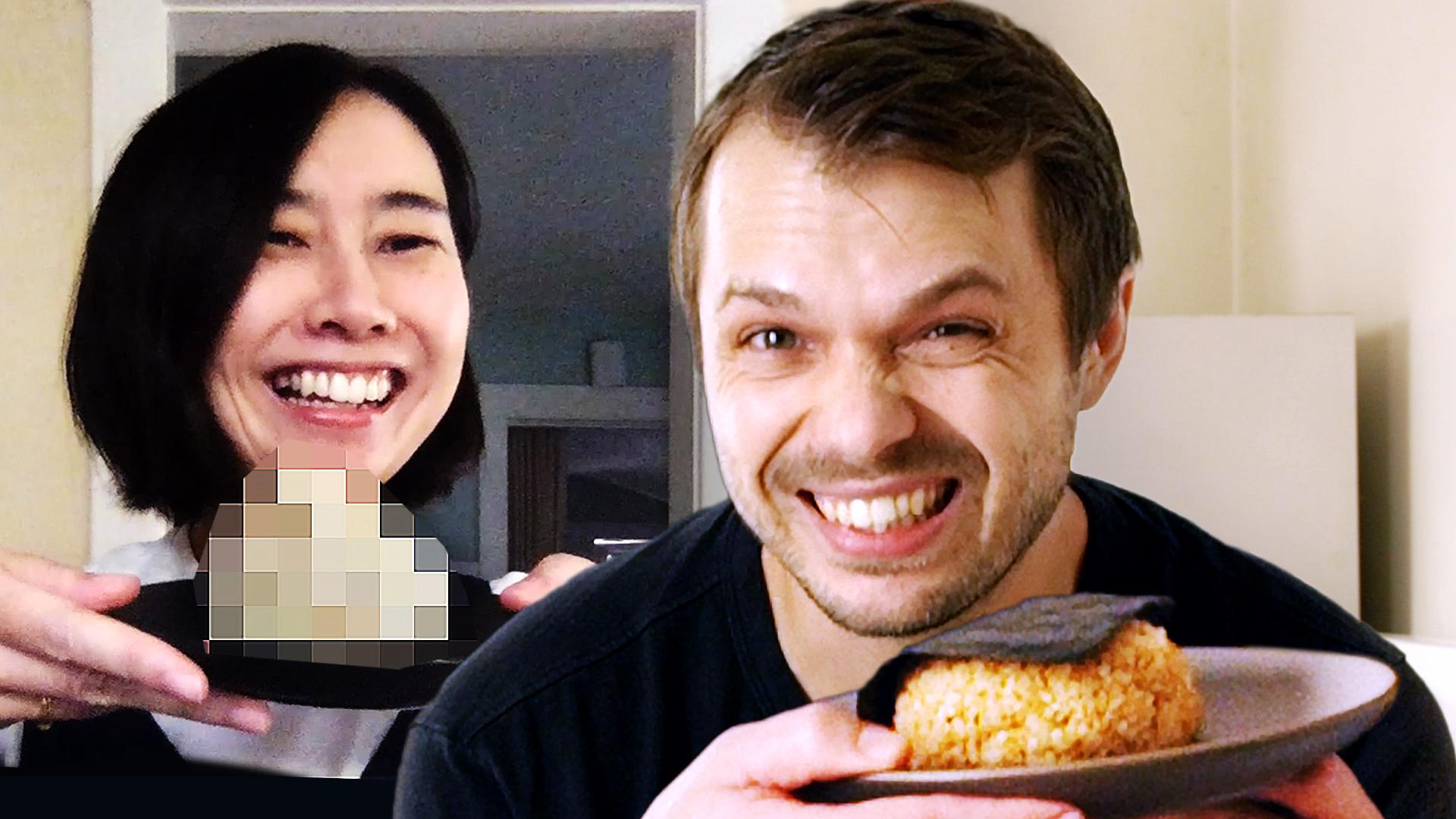 Andrew and Rie holding plated dishes.