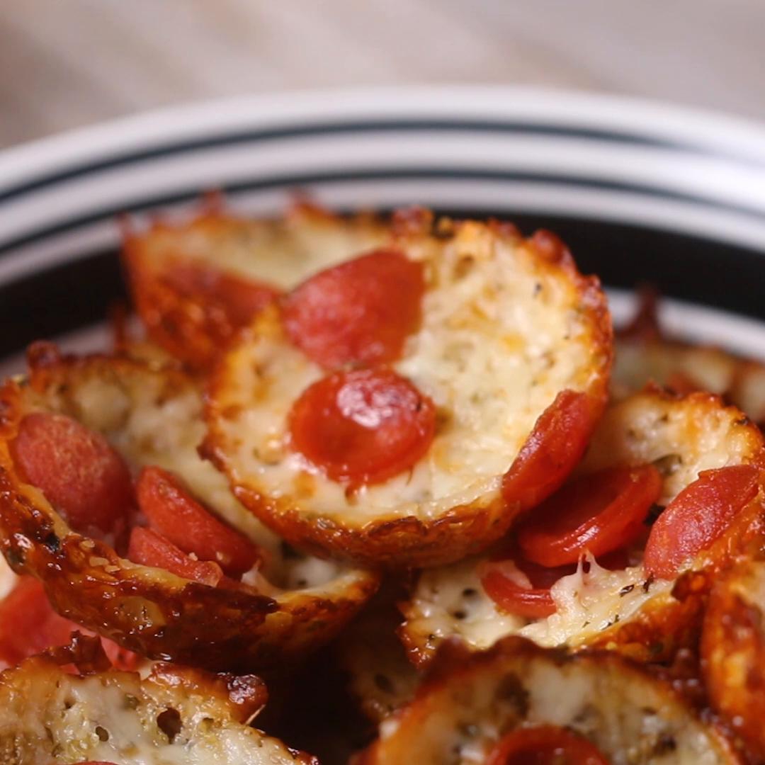 recipes Mini pepperoni pizza bites on a plate, topped with melted cheese and pepperoni slices