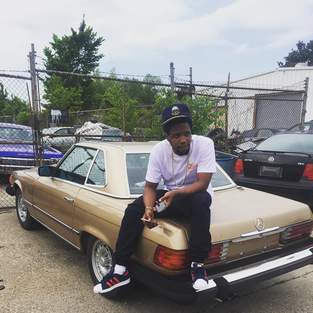 Currensy wearing the adidas Superstar in Navy/Red