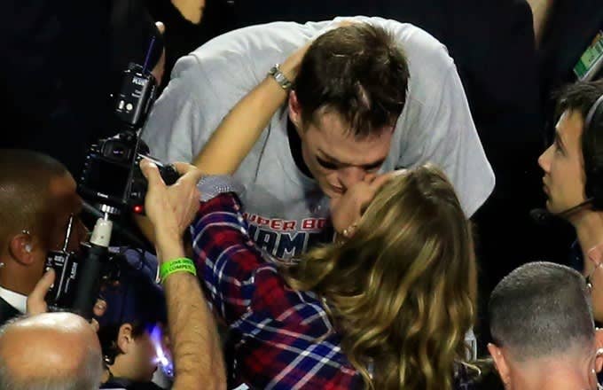 Tom Brady and Gisele Bundchen kiss after Super Bowl 49.
