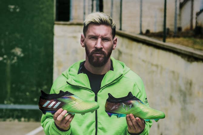 Messi Holding Adidas Cleats