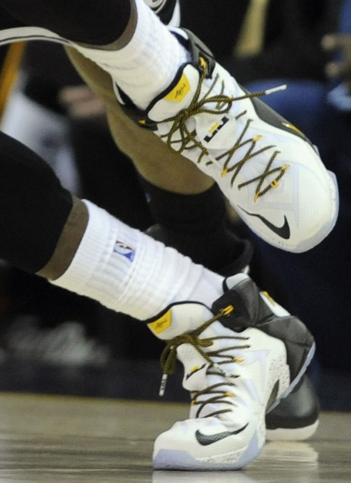 LeBron James wearing Nike LeBron XII 12 White/Black-Yellow PE on December 19, 2014