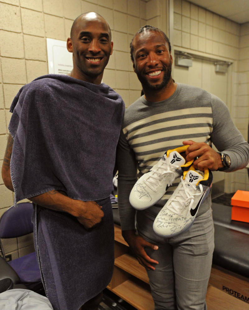 Kobe Bryant Signs Sneakers for Larry Fitzgerald