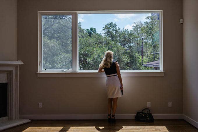 Women Looking Out The Window Holding A Handgun