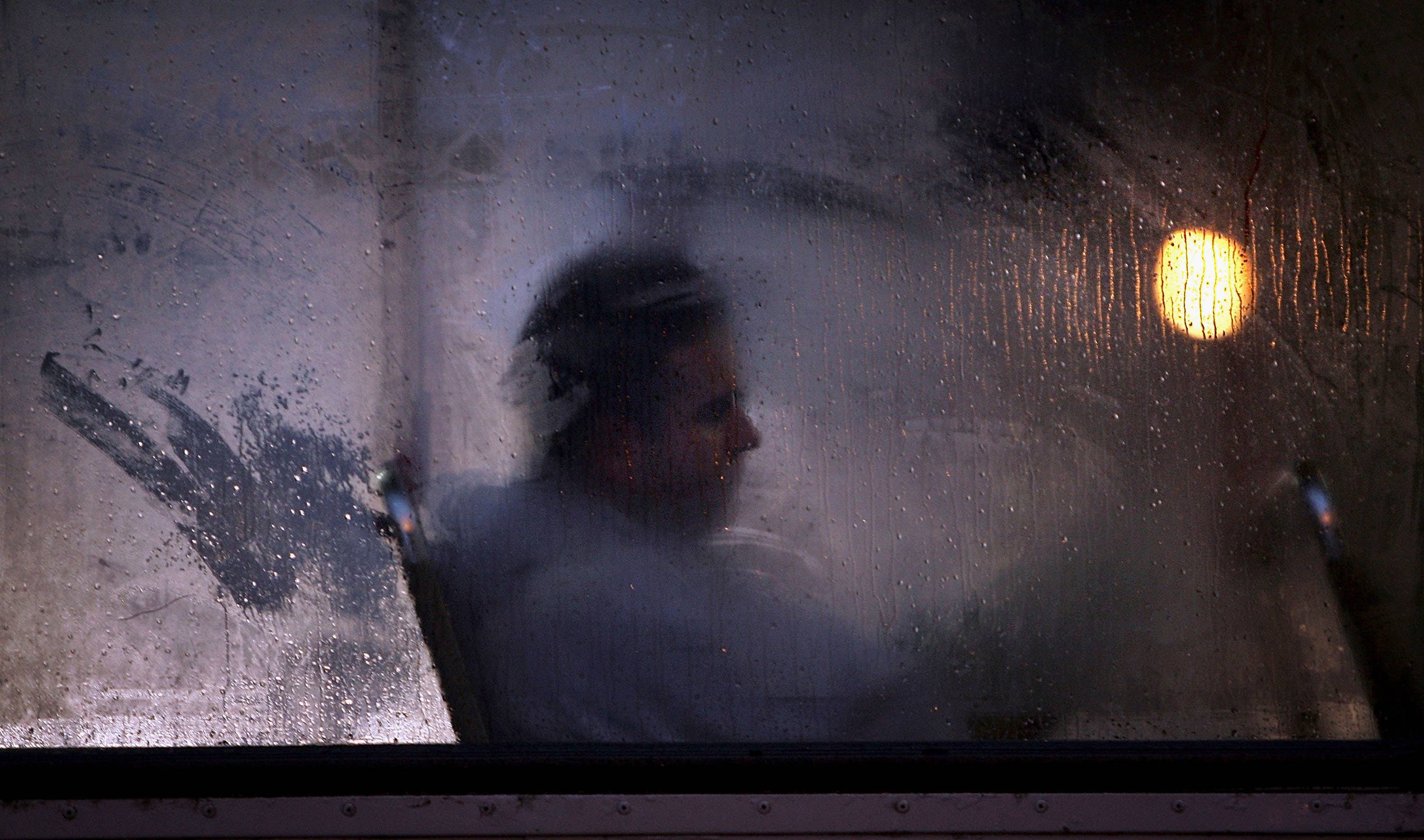 Man Sitting Next To Foggy Window Image