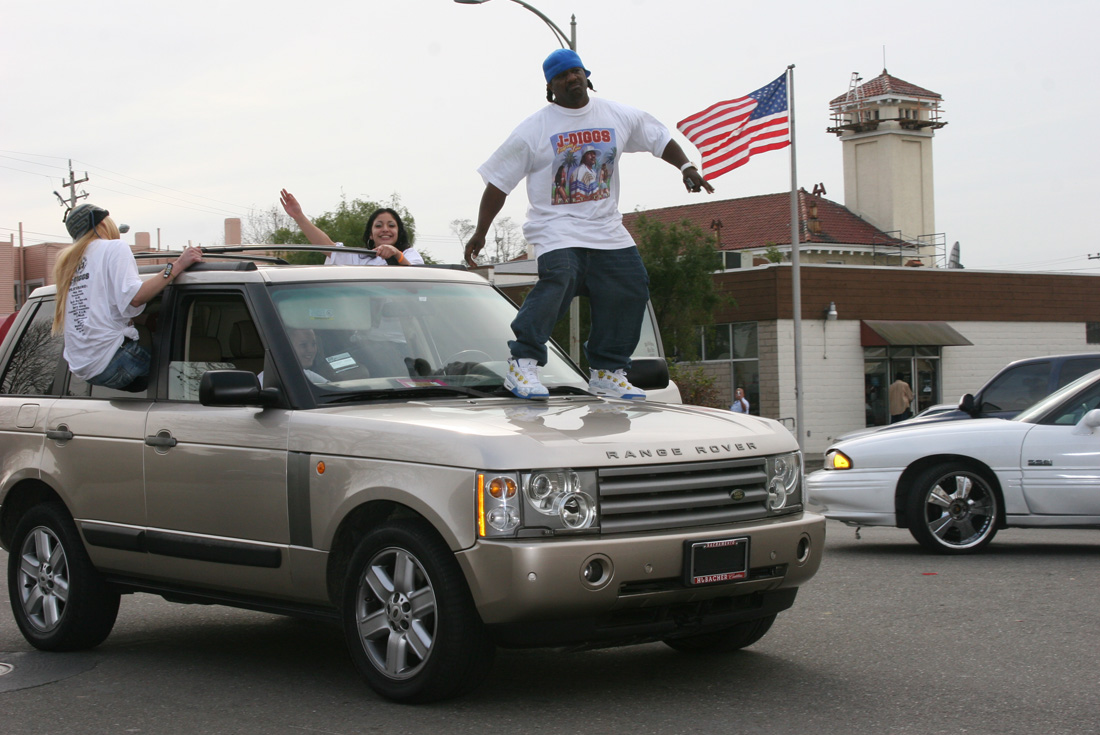 J Diggs ghost riding a Range Rover on the set of the 2006 music video shoot for E 40&#x27;s &quot;Tell Me When To Go.&quot; 