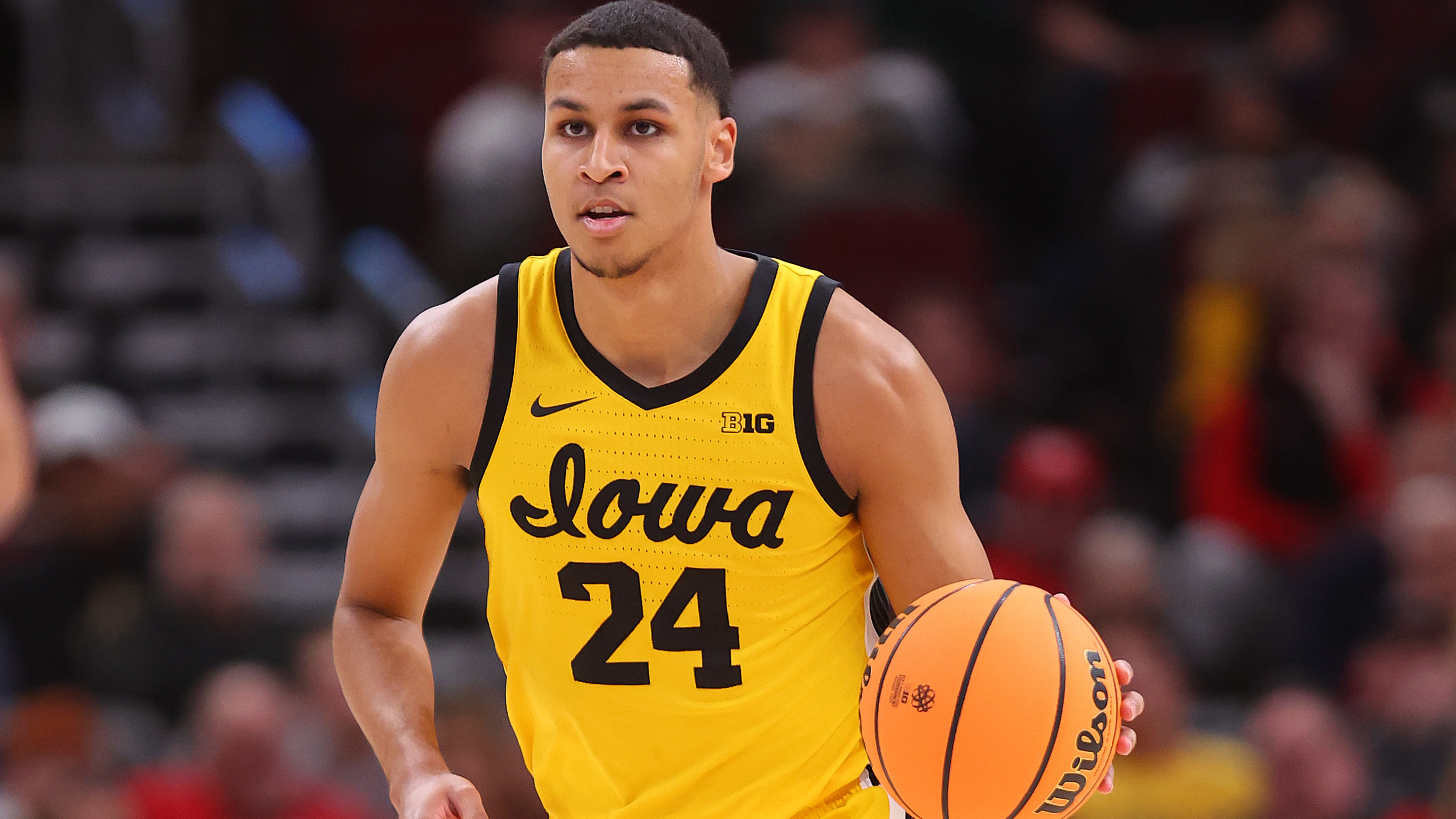 Kris Murray dribbling the ball up the floor for Iowa