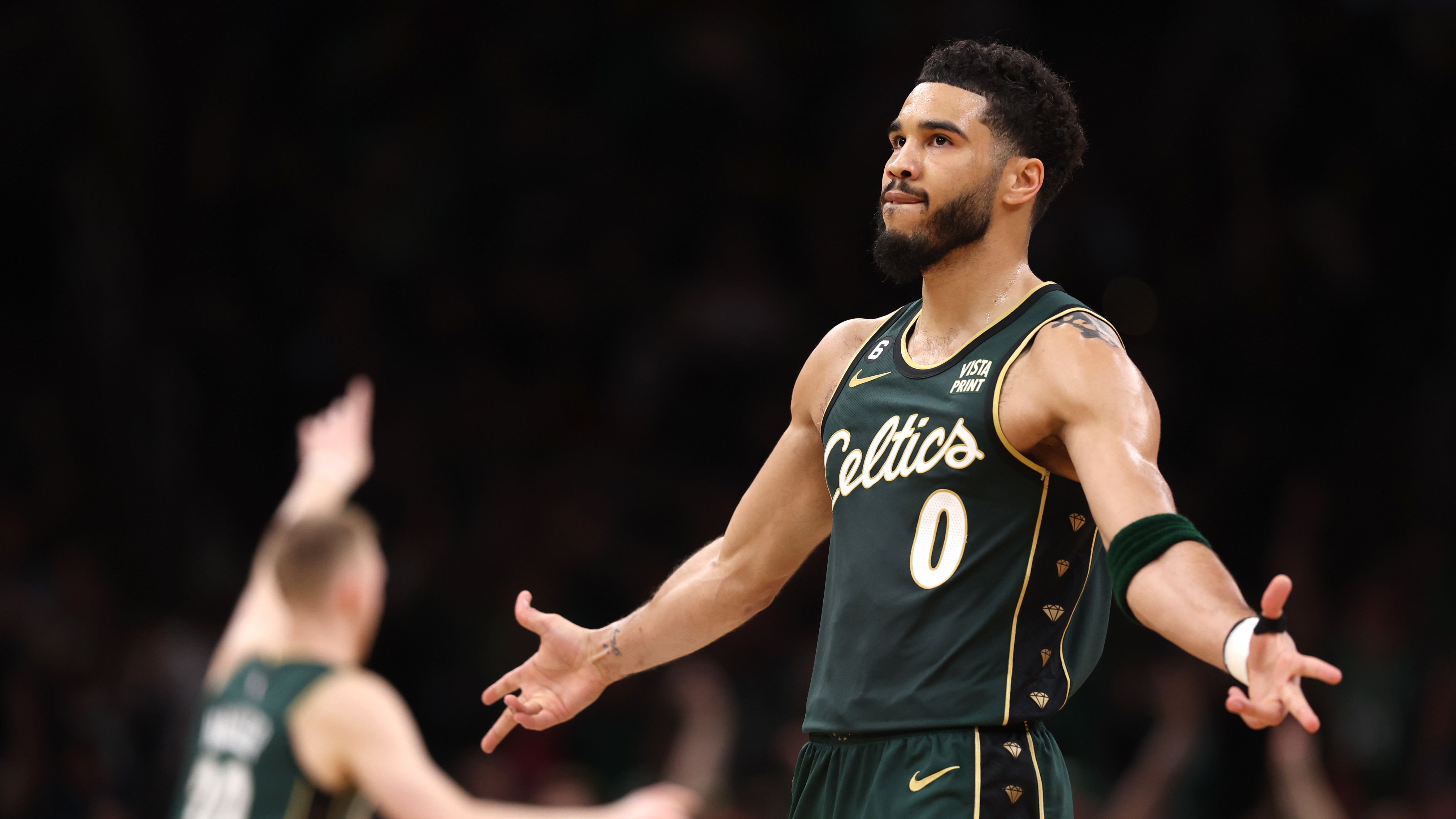 Jayson Tatum of the Boston Celtics celebrates after hitting a three point shot