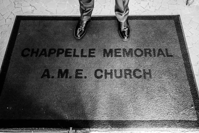 Dave Chappelle standing on the doorstep of Chappelle Memorial A.M.E. Church