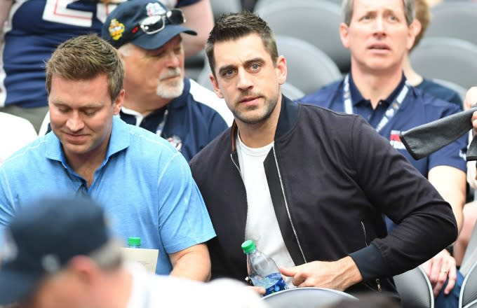Aaron Rodgers watches an NBA game.