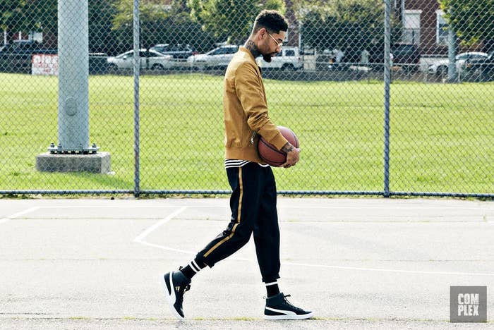 PnB Rock wearing the PUMA Clyde Mid-Foil Sneakers