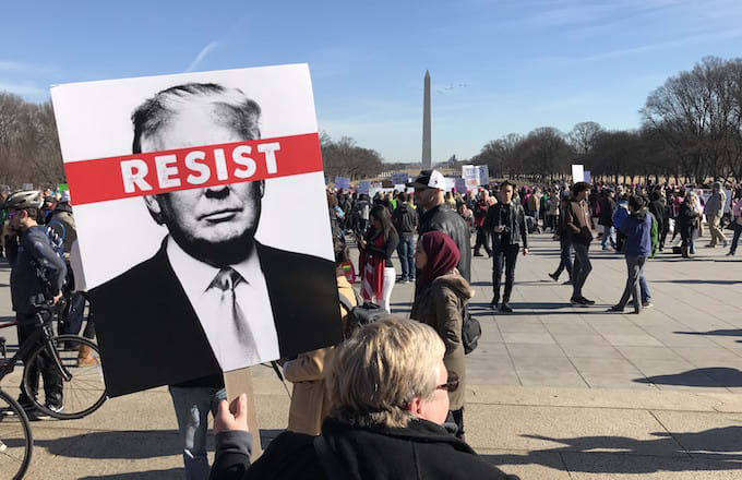 A demonstrator hold a banner at Washington, D.C.