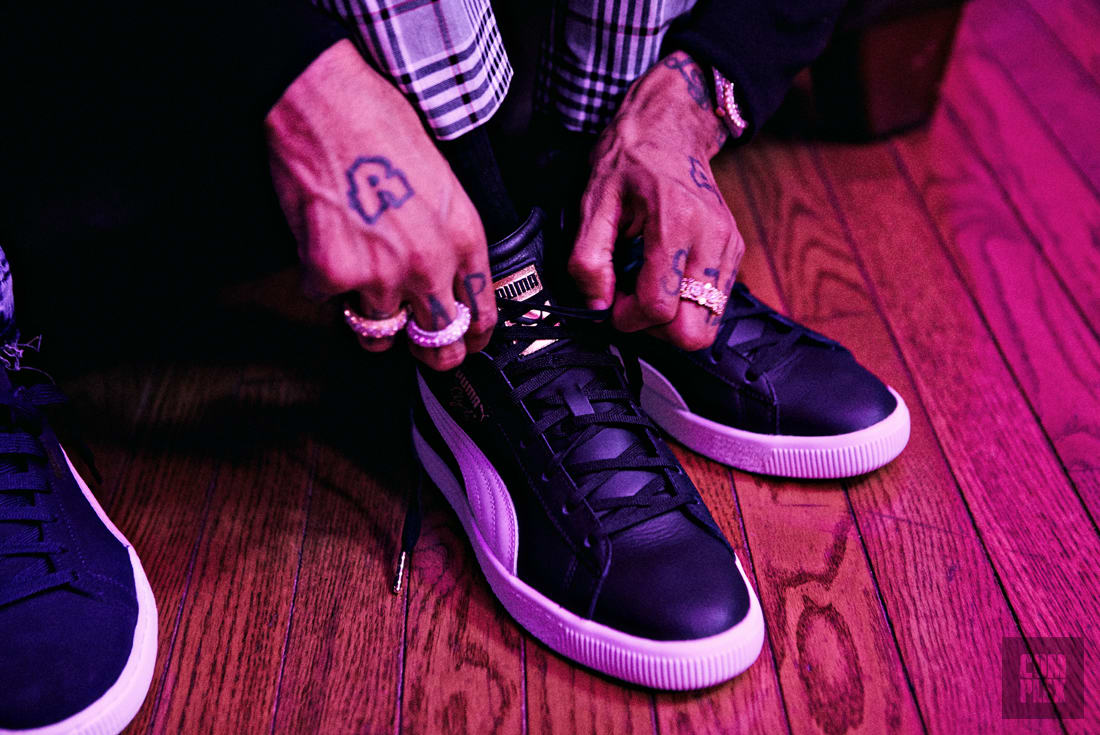 PnB Rock wearing the PUMA Clyde Mid-Foil Sneakers