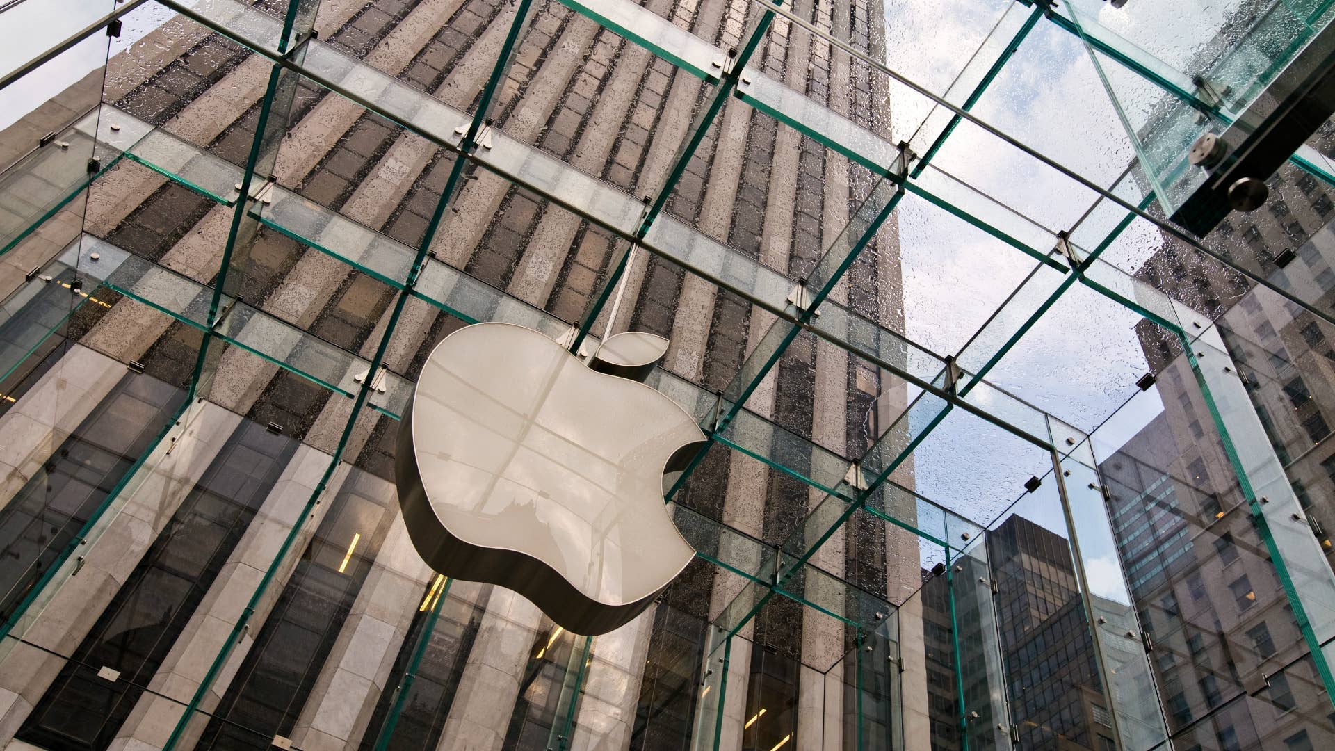 An Apple logo is pictured in a city environment