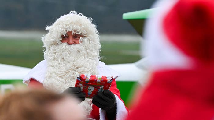 Santa claus stock photo, holding out a gift