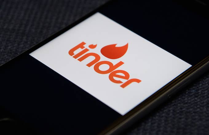 The 'Tinder' app logo is seen on a mobile phone screen
