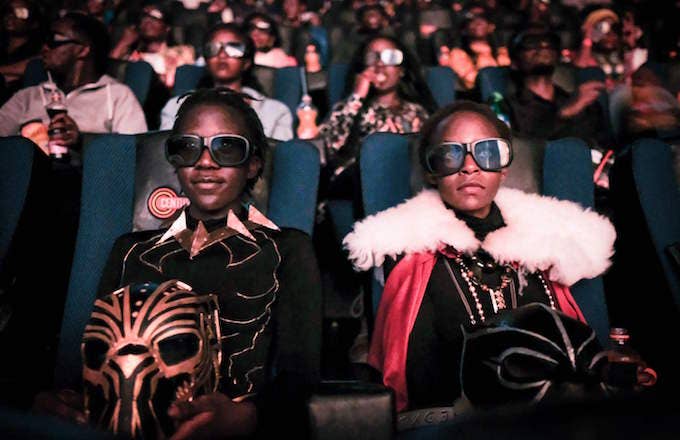 Cosplayers watching the film &#x27;Black Panther&#x27; in 3D.