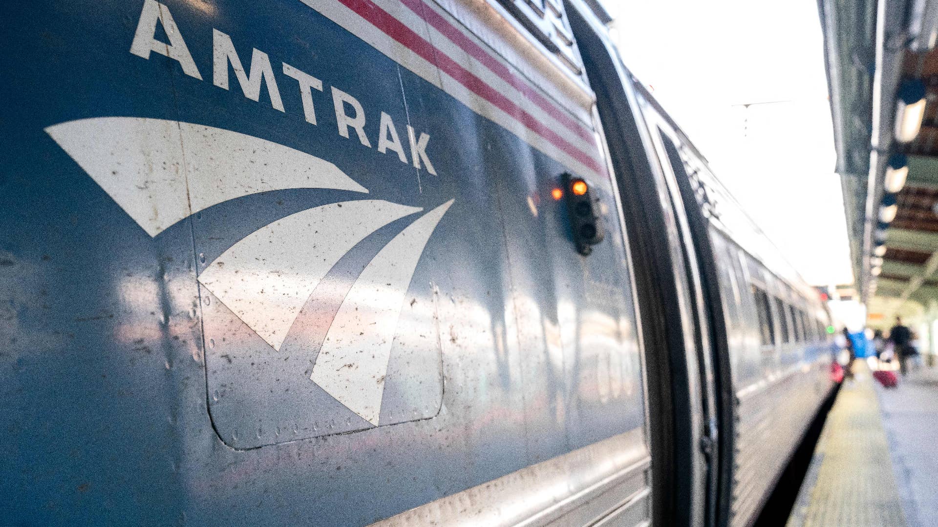 The Amtrak logo is seen on a train at station.