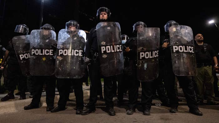 Detroit Police officers watch demonstrators in the city of Detroit, Michigan