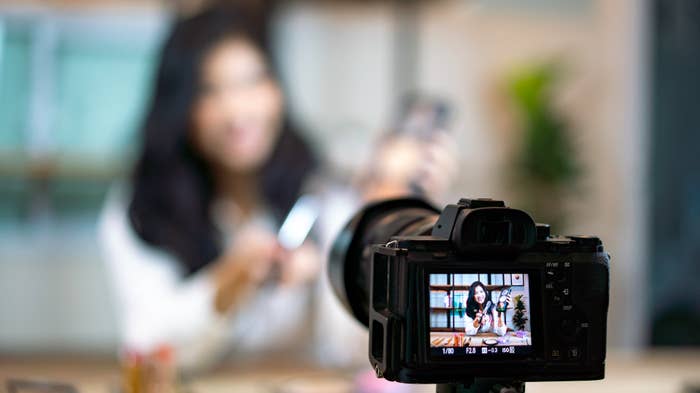 This is an image of a female recording herself