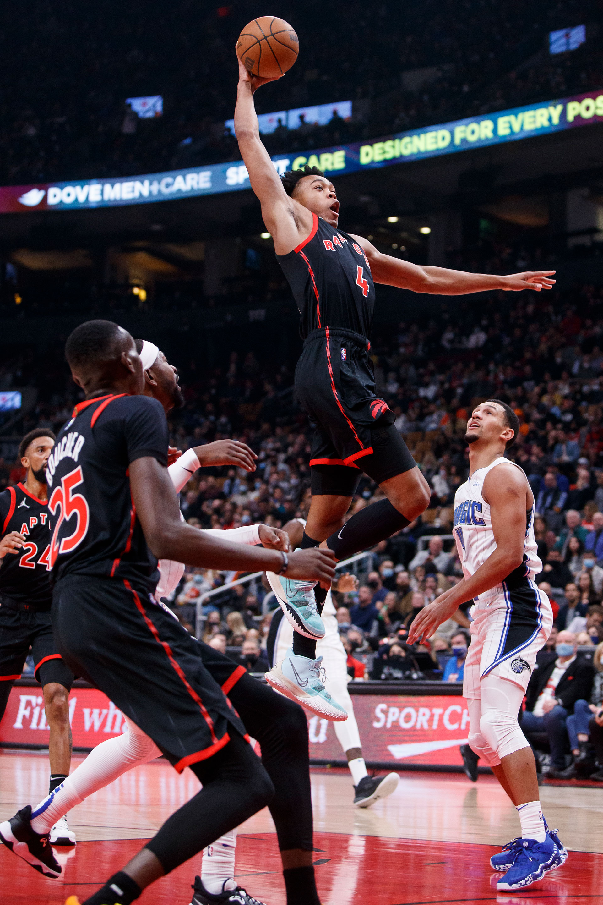 Scottie Barnes #4 of the Toronto Raptors goes up for a dunk against Jalen Suggs #4 of the Orlando Magic during the first half of their NBA game