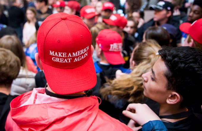 Students touring Congress in MAGA hat