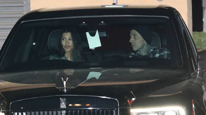 Kourtney Kardashian and Travis Barker being hounded by the paparazzi.