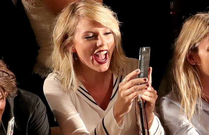Taylor Swift checks her phone.