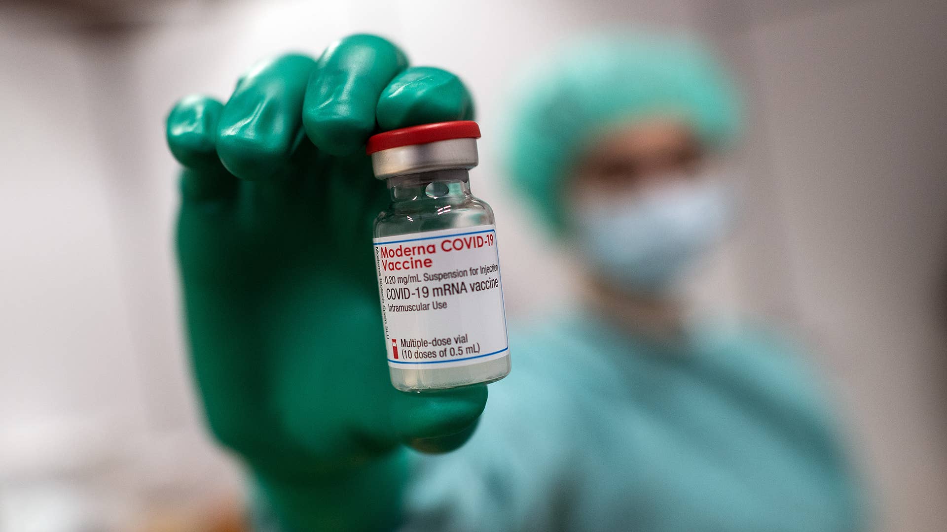A doctor holds a jar of Moderna's vaccine against Covid 19