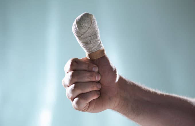Stock photo of a bandaged thumb.