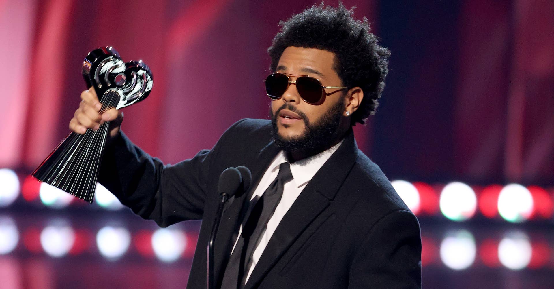 The Weeknd accepting an award at iHeartRadioMusic awards