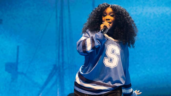 A photo of SZA performing on stage.