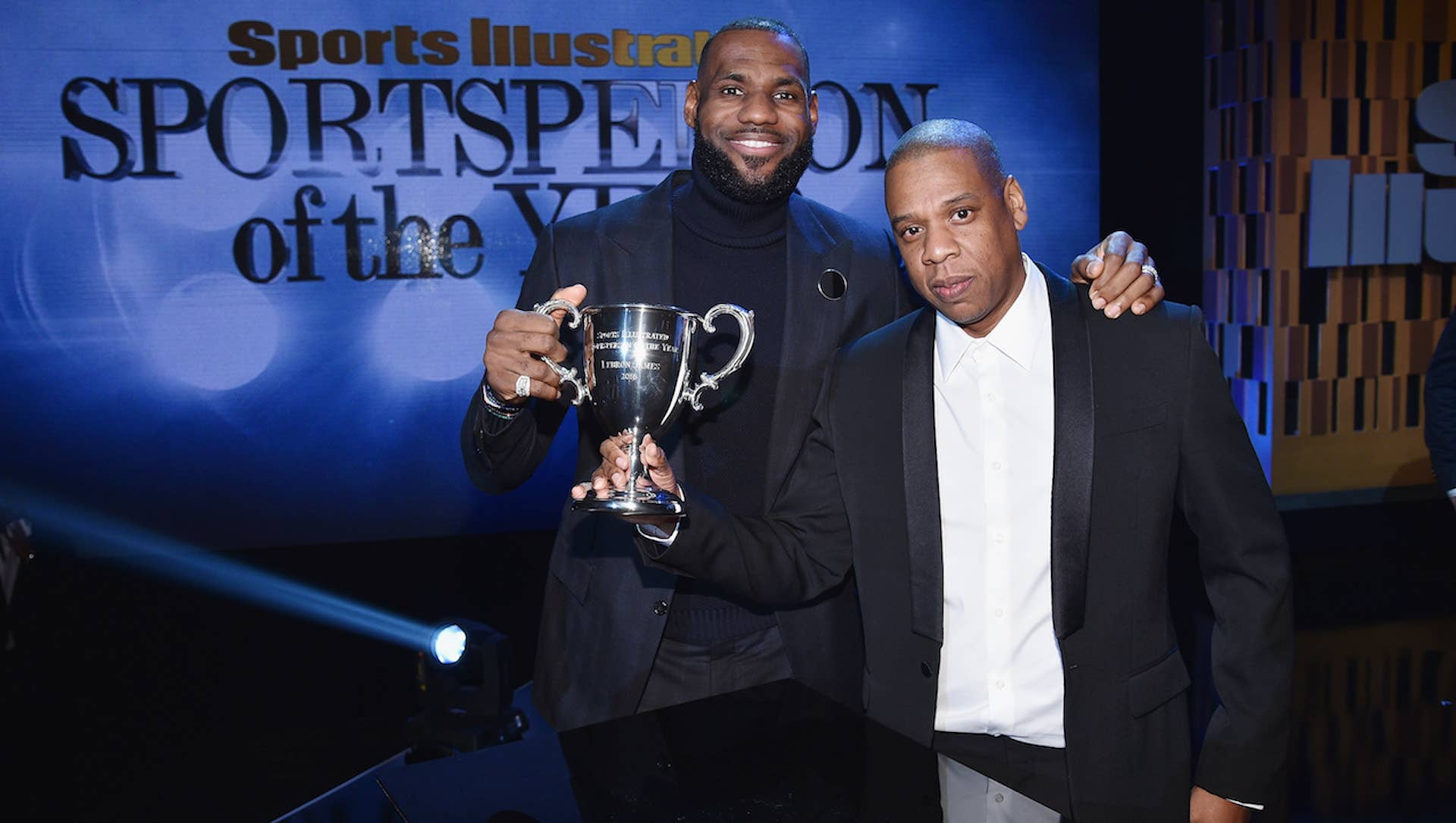 LeBron James and Jay Z pose onstage with an award during the Sports Illustrated Sportsperson of the Year Ceremony 2016 at Barclays Center of Brooklyn
