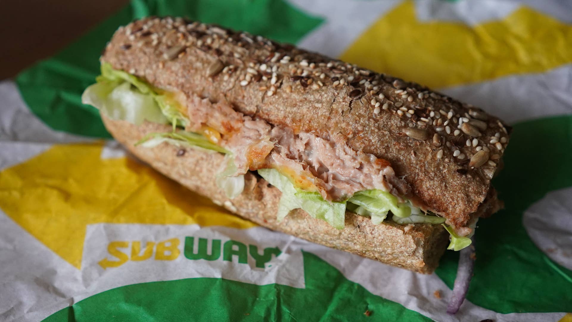 A "Tuna Sandwich" from the fast food chain "Subway" lies on a table.