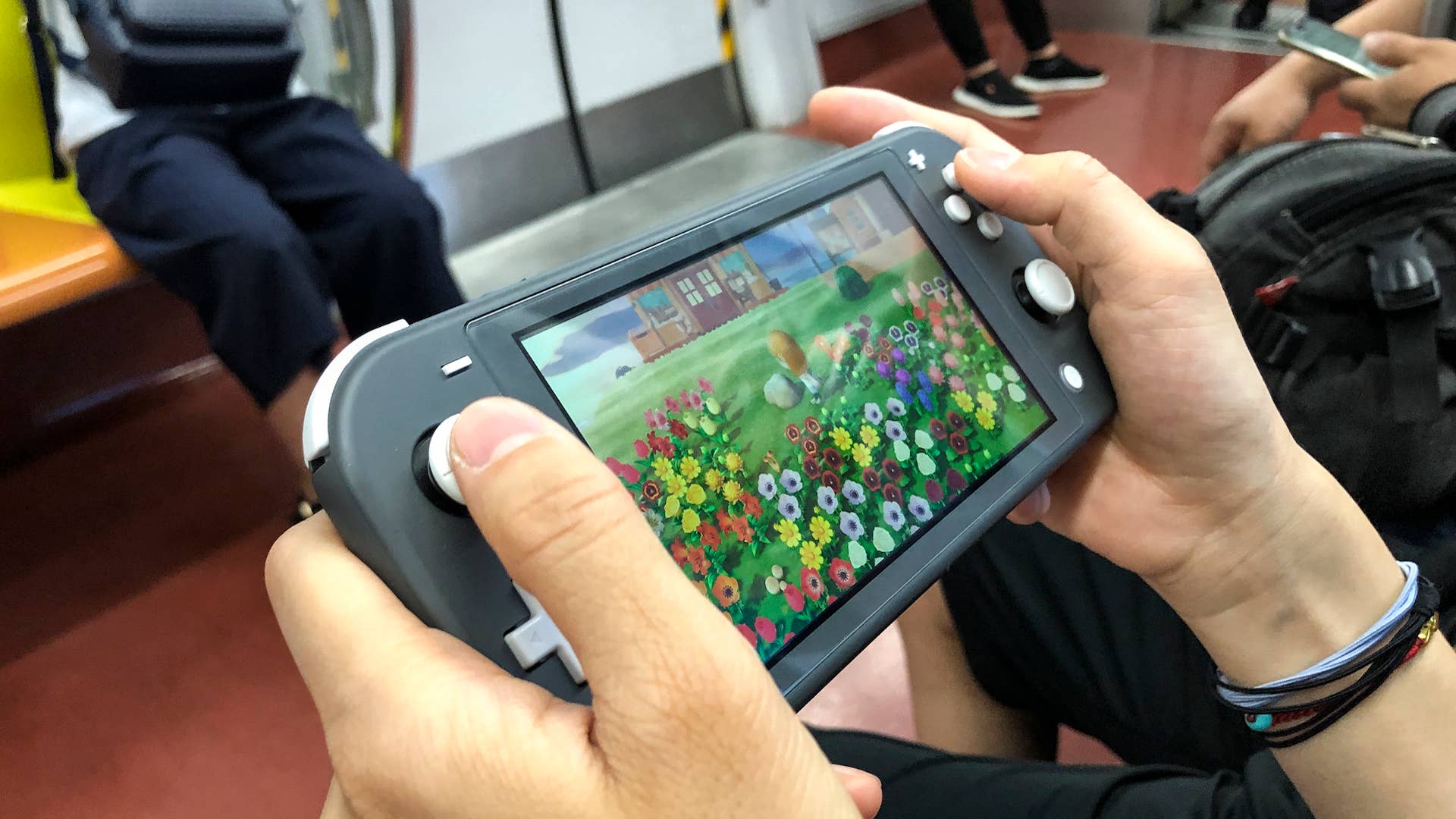 A passenger uses a Nintendo Switch