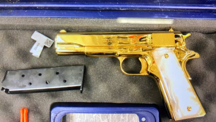 gold plated gun is pictured in case
