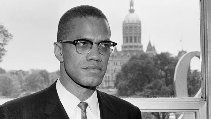 Malcolm X, is shown with the dome of the Connecticut Capitol behind him.