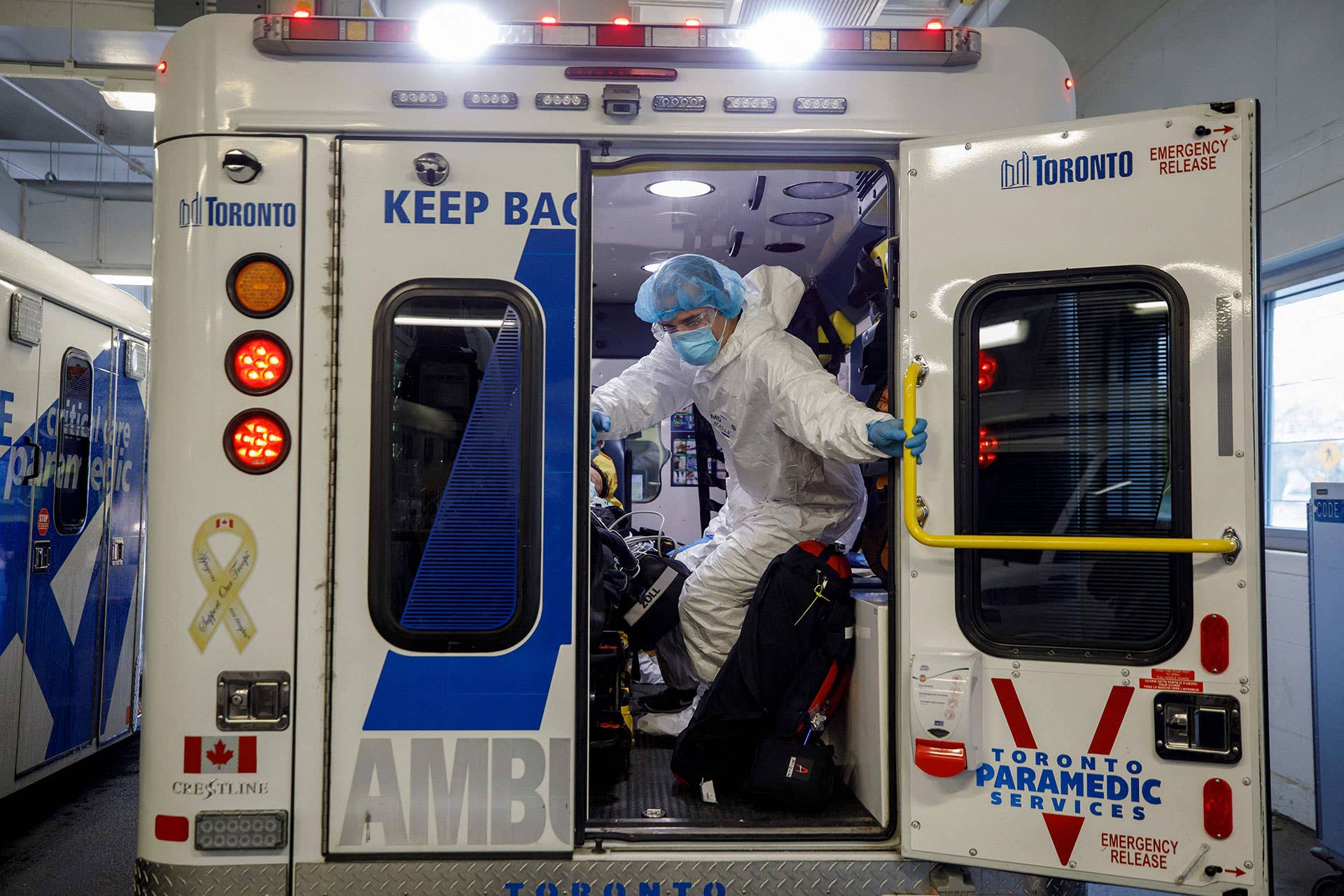 Paramedics and healthcare workers transfer a patient from Humber River Hospital's Intensive Care Unit to a waiting air ambulance as the hospital frees up space In their ICU unit, in Toronto, Ontario, Canada, on April 28, 2021.