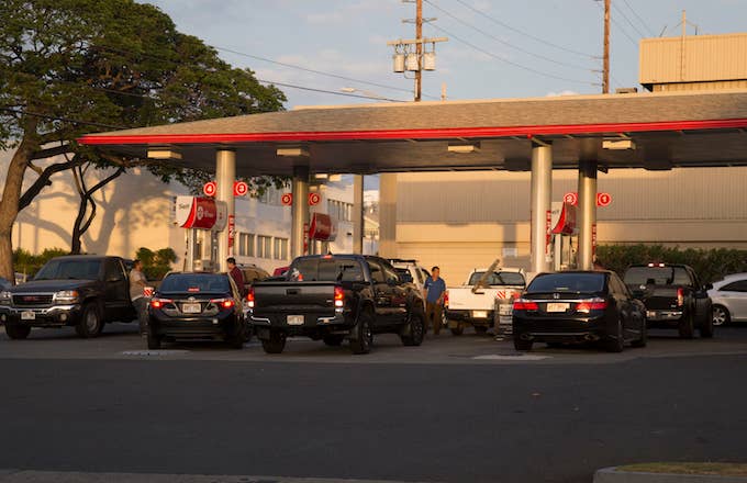 Continuous lines of vehicles find gasoline at the Texaco station.