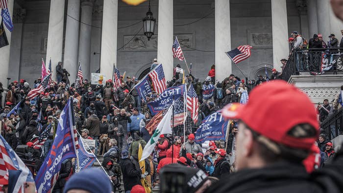 Trump supporters take the steps on the east side of the US Capitol building on January 06, 2021