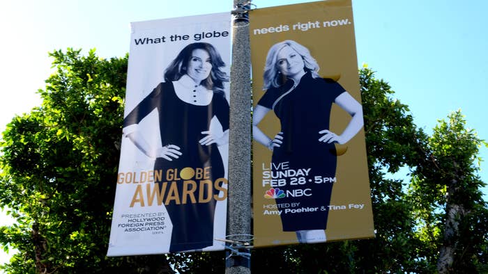 A sign advertises Tina Fey and Amy Poehler hosting the 2021 Golden Globes.