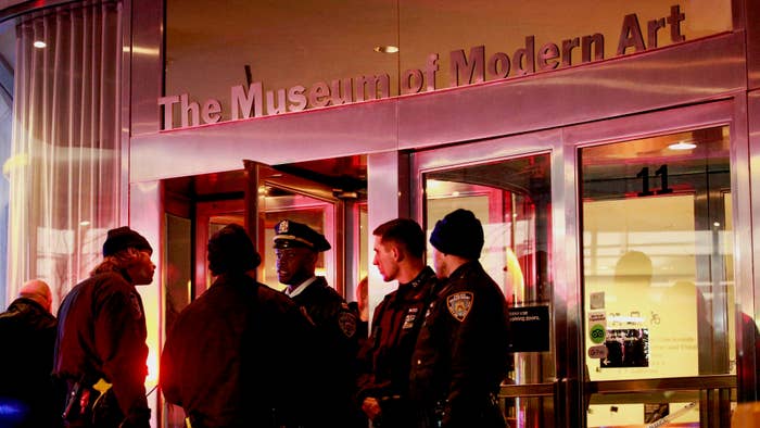 New York City police officers stand guard at the entrance of the Museum of Modern Art