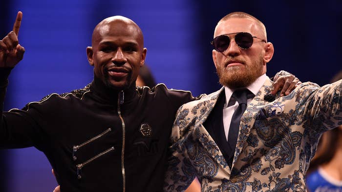 Floyd Mayweather Jr. and Conor McGregor pose for pictures during a news conference
