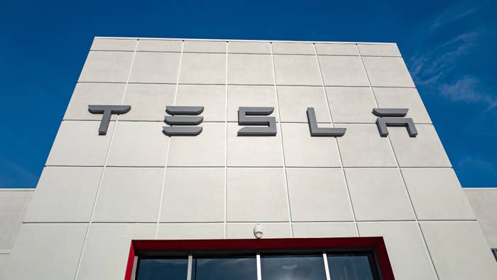 A logo for the Tesla company is pictured