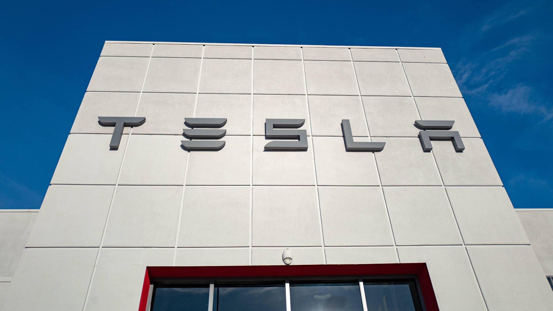 A logo for the Tesla company is pictured