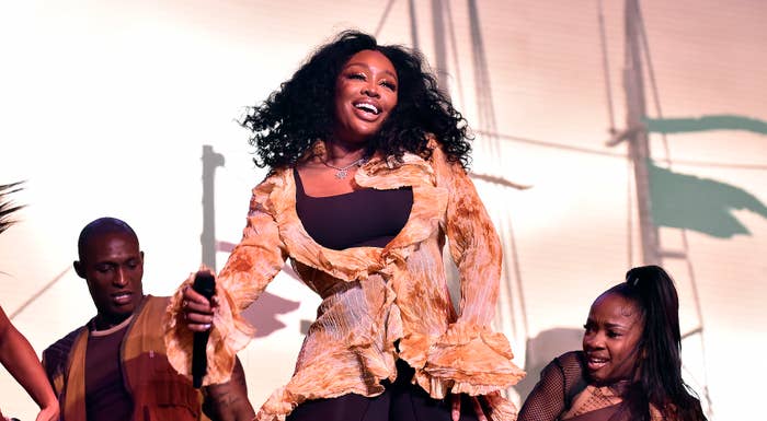 SZA onstage at a festival with dancers