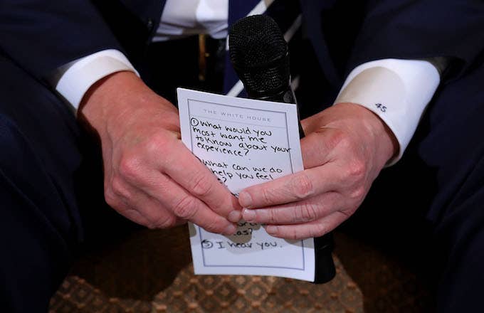 Donald Trump holds his notes